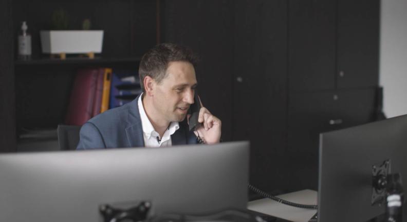 Mann telefoniert in einem Büro
